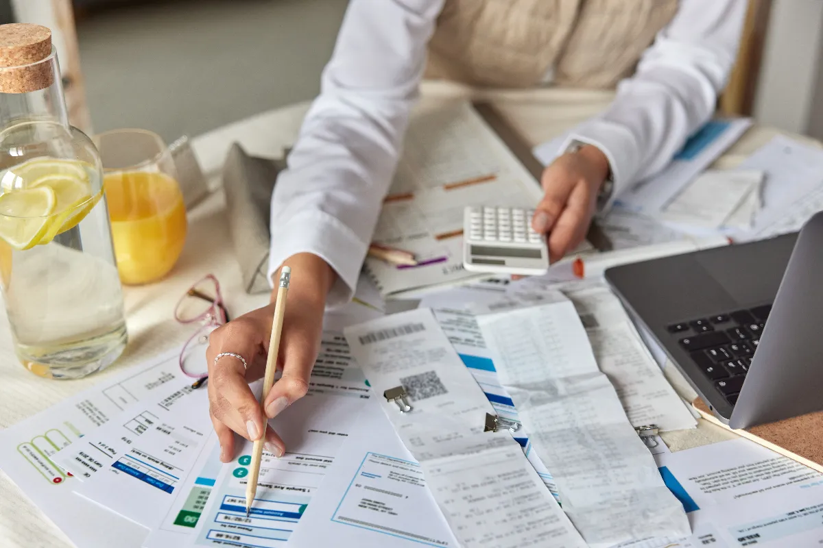 woman-calculating-finances-at-desk-with-laptop